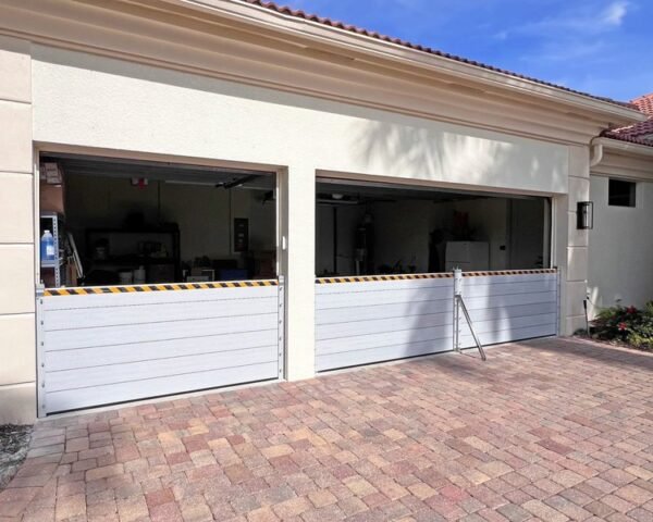 Barrier system protecting dual commercial garage entrances from floodwater in Dania Beach