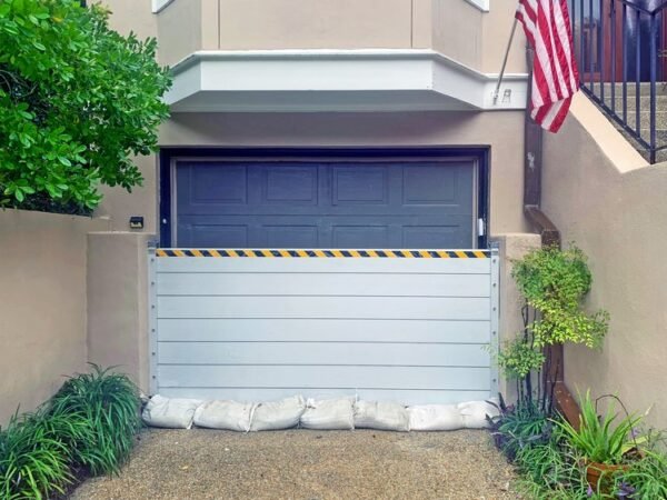 Aluminum flood barrier sealing garage door against stormwater in Boca Raton