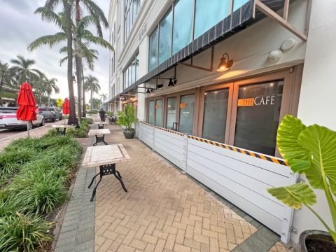 Outdoor view of flood panels installed in front of business entrance for water damage prevention in South Florida