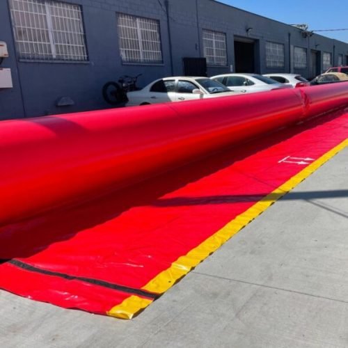 Inflatable red flood tubes used for commercial waterproofing and flood protection in Hollywood, Florida